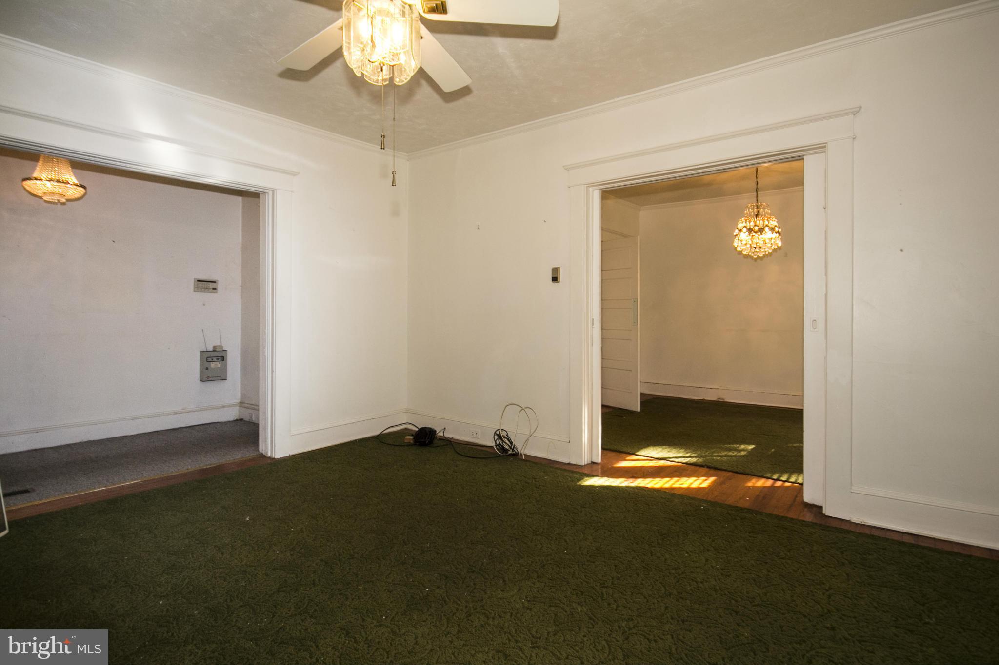 1803 Chelsea Road Baltimore, MD 21216 - Photo 6 of 30 a view of room with window and chandelier fan