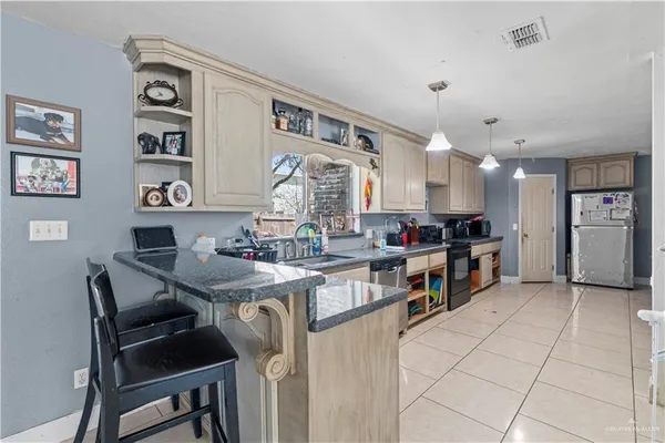 a kitchen with stainless steel appliances kitchen island granite countertop a sink and cabinets