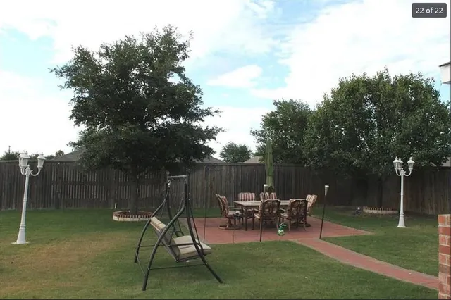 a view of chair and tables in the back yard