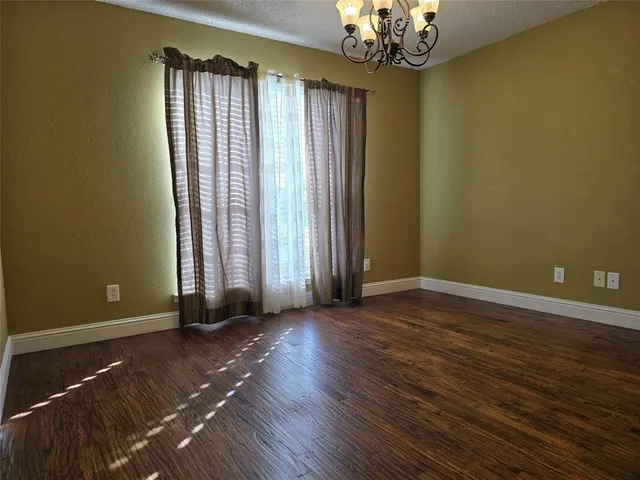 a view of an empty room with a fireplace and a window