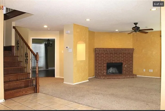 a view of an empty room and fire place