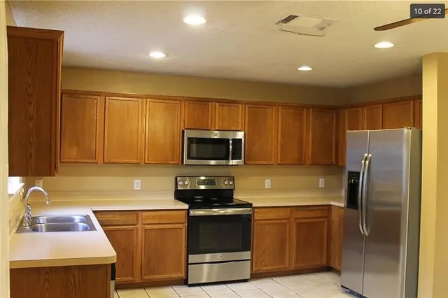 a kitchen with a refrigerator sink and microwave