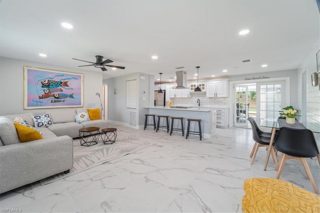 3999 Guava Drive Naples, FL 34104 - Photo 1 of 24 a living room with furniture and a view of kitchen