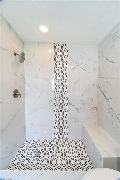 3999 Guava Drive Naples, FL 34104 - Photo 11 of 24 a bathroom with a bathtub and shower