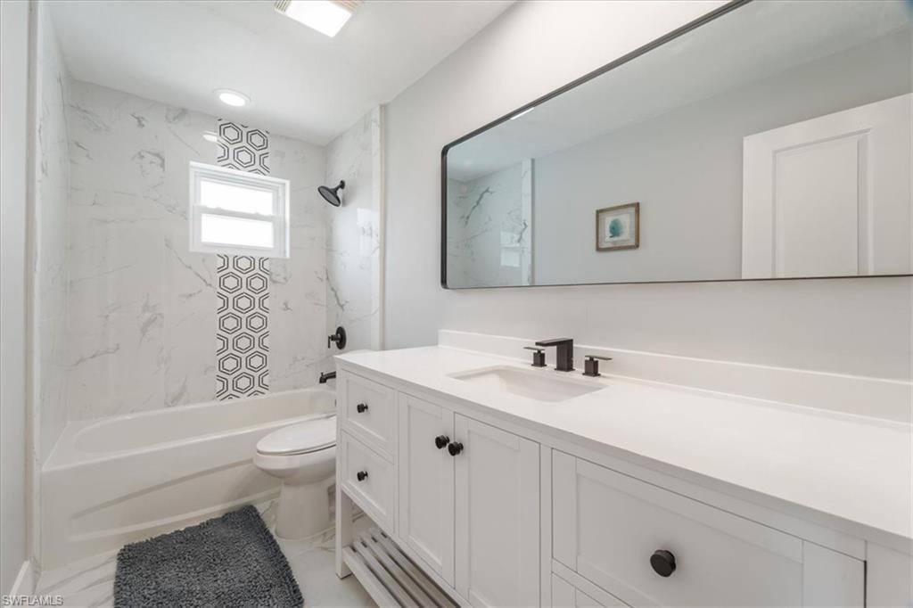 3999 Guava Drive Naples, FL 34104 - Photo 12 of 24 a bathroom with a sink a toilet and shower