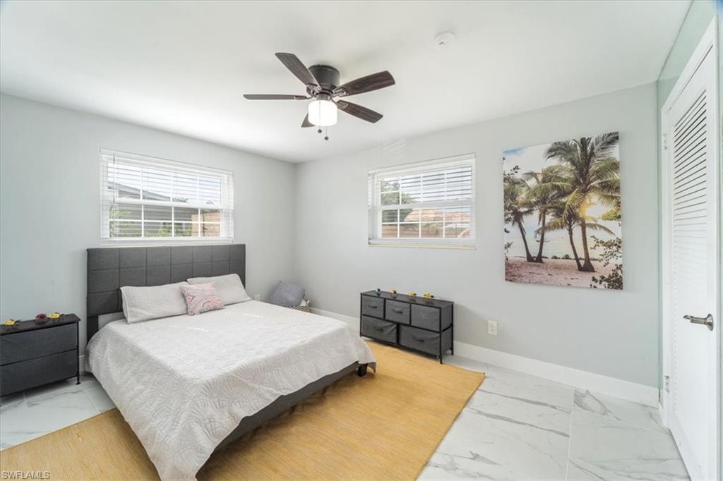 3999 Guava Drive Naples, FL 34104 - Photo 15 of 24 a bedroom with a large bed and a window