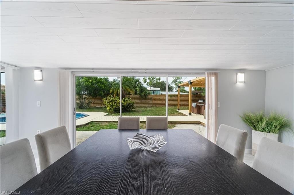 3999 Guava Drive Naples, FL 34104 - Photo 16 of 24 a swimming pool with outdoor seating and yard