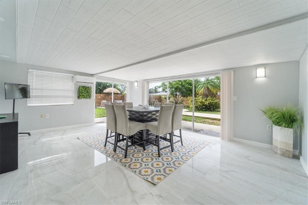 3999 Guava Drive Naples, FL 34104 - Photo 17 of 24 a view of a dining room with furniture window and outside view