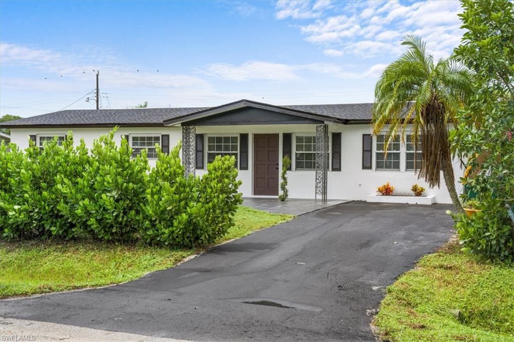 3999 Guava Drive Naples, FL 34104 - Photo 23 of 24 a front view of a house with garden