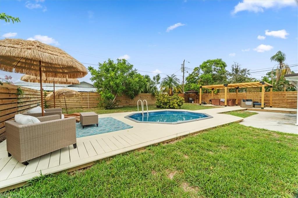 3999 Guava Drive Naples, FL 34104 - Photo 4 of 24 a view of swimming pool with a yard