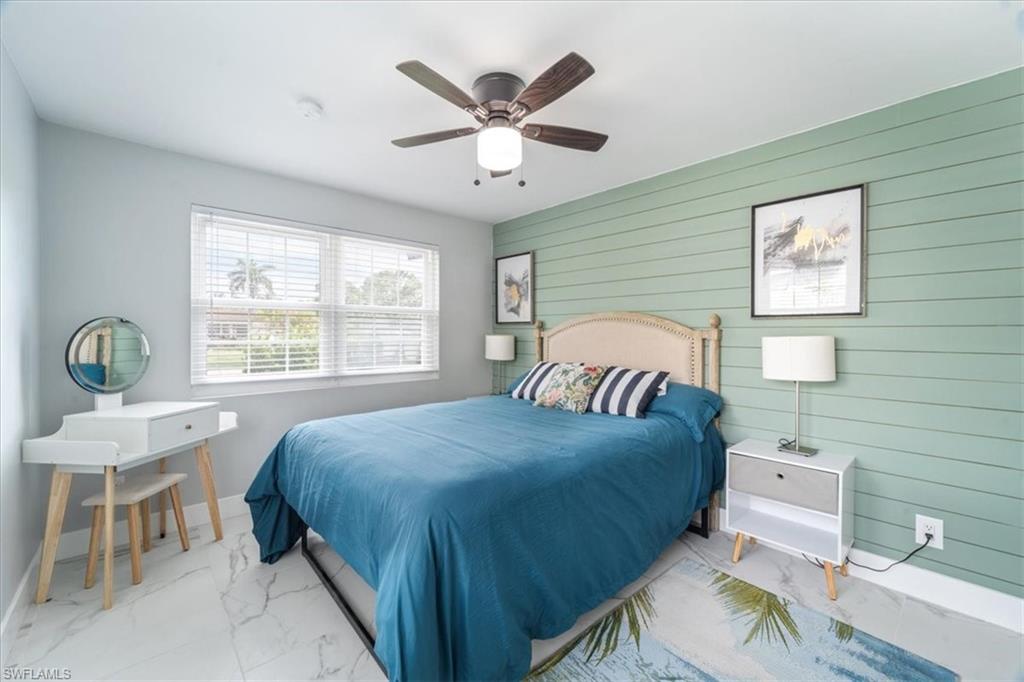 3999 Guava Drive Naples, FL 34104 - Photo 8 of 24 a bedroom with a bed and a table in it