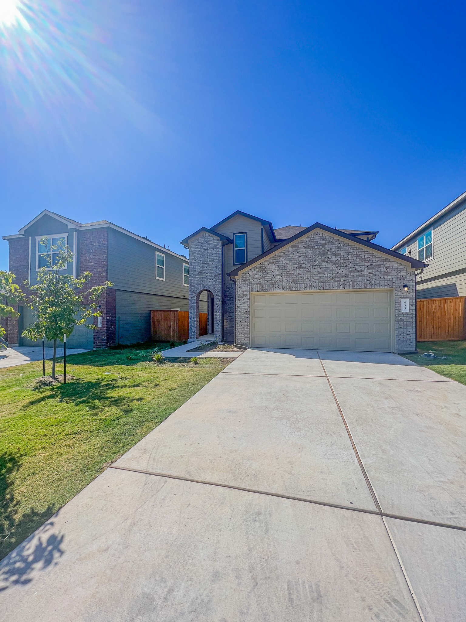 438 Perfect World Loop Jarrell, TX 76537 - Photo 2 of 35 a front view of a house with a garden and yard