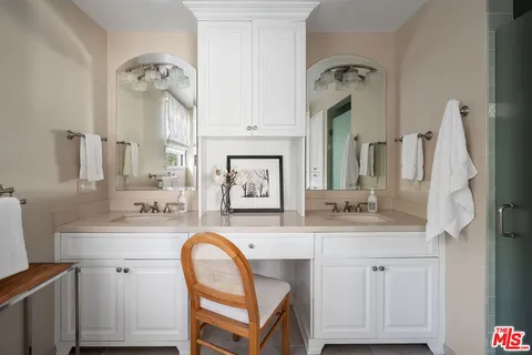 a bathroom with a sink vanity and a mirror