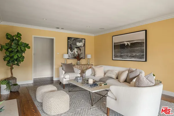 a living room with furniture and a potted plant