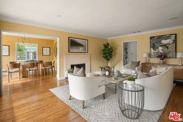 a living room with furniture a fireplace and a table