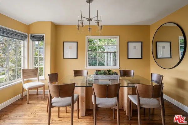 a dining room with furniture and a window