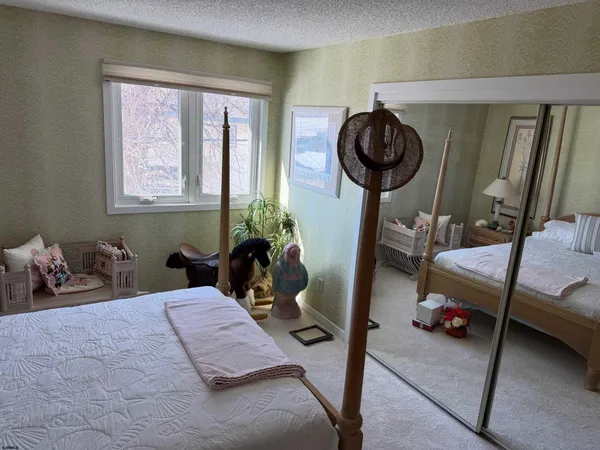 a bedroom with furniture and a mirror