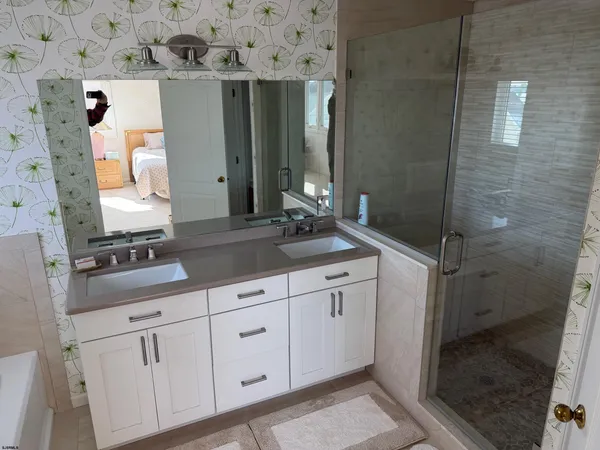 a bathroom with a double vanity sink and a mirror