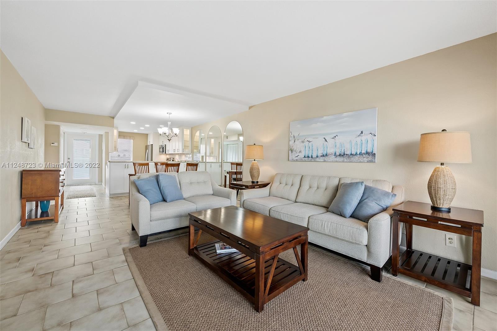 1401 North Riverside Drive, Unit 503 Pompano Beach, FL 33062 - Photo 11 of 30 a living room with furniture and a lamp