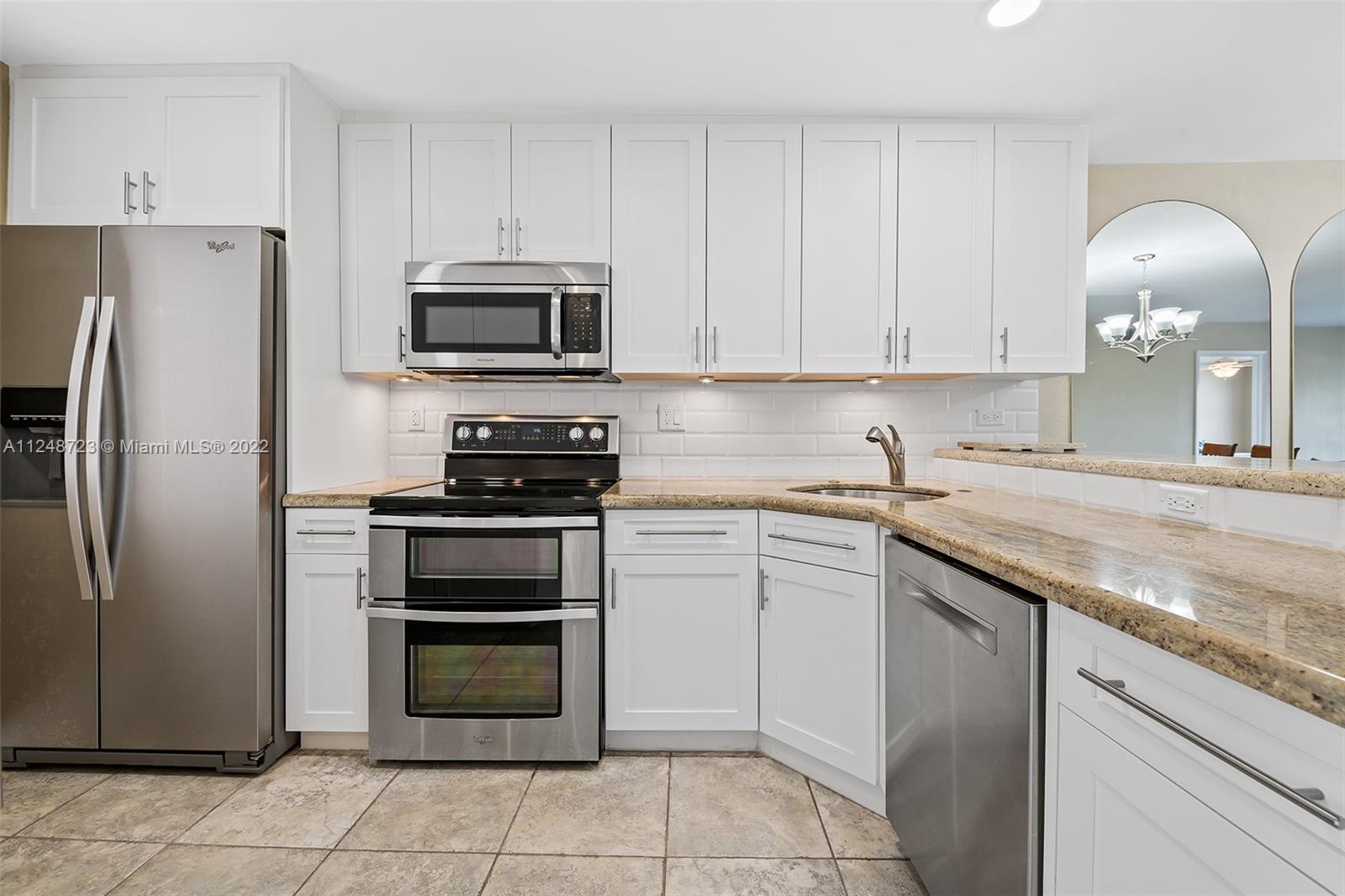 1401 North Riverside Drive, Unit 503 Pompano Beach, FL 33062 - Photo 12 of 30 a kitchen with cabinets stainless steel appliances and a sink