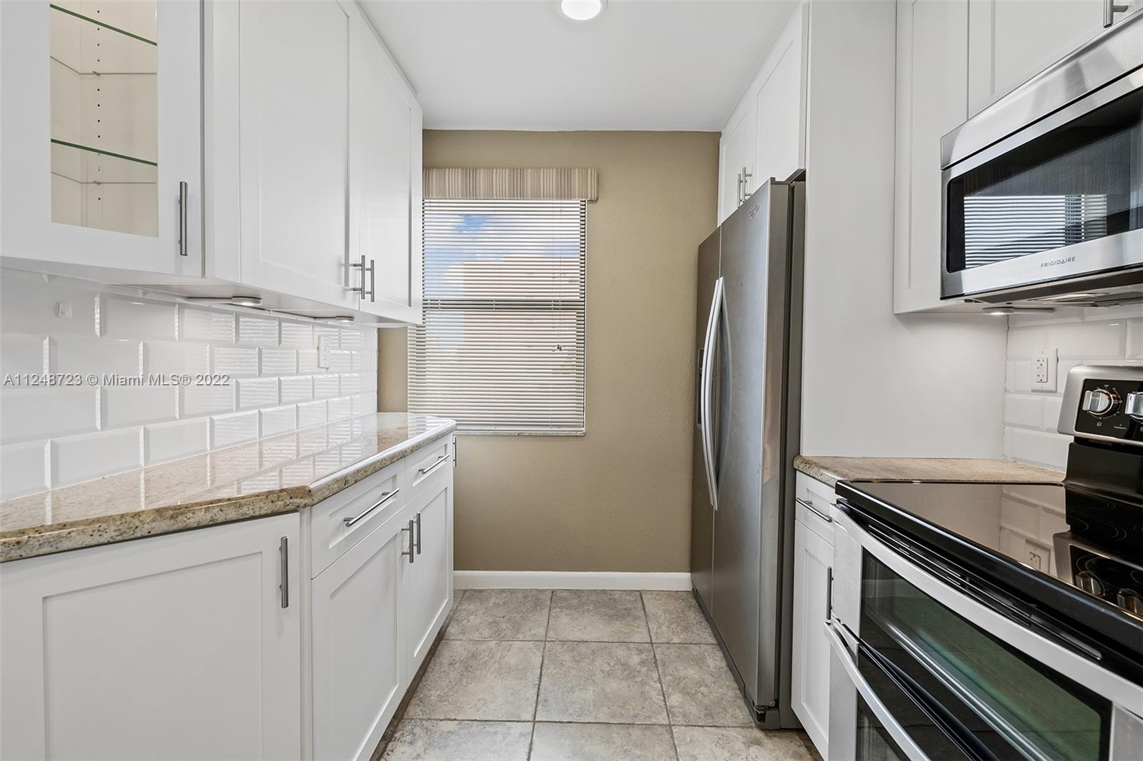 1401 North Riverside Drive, Unit 503 Pompano Beach, FL 33062 - Photo 14 of 30 a kitchen with stainless steel appliances granite countertop a refrigerator and a sink