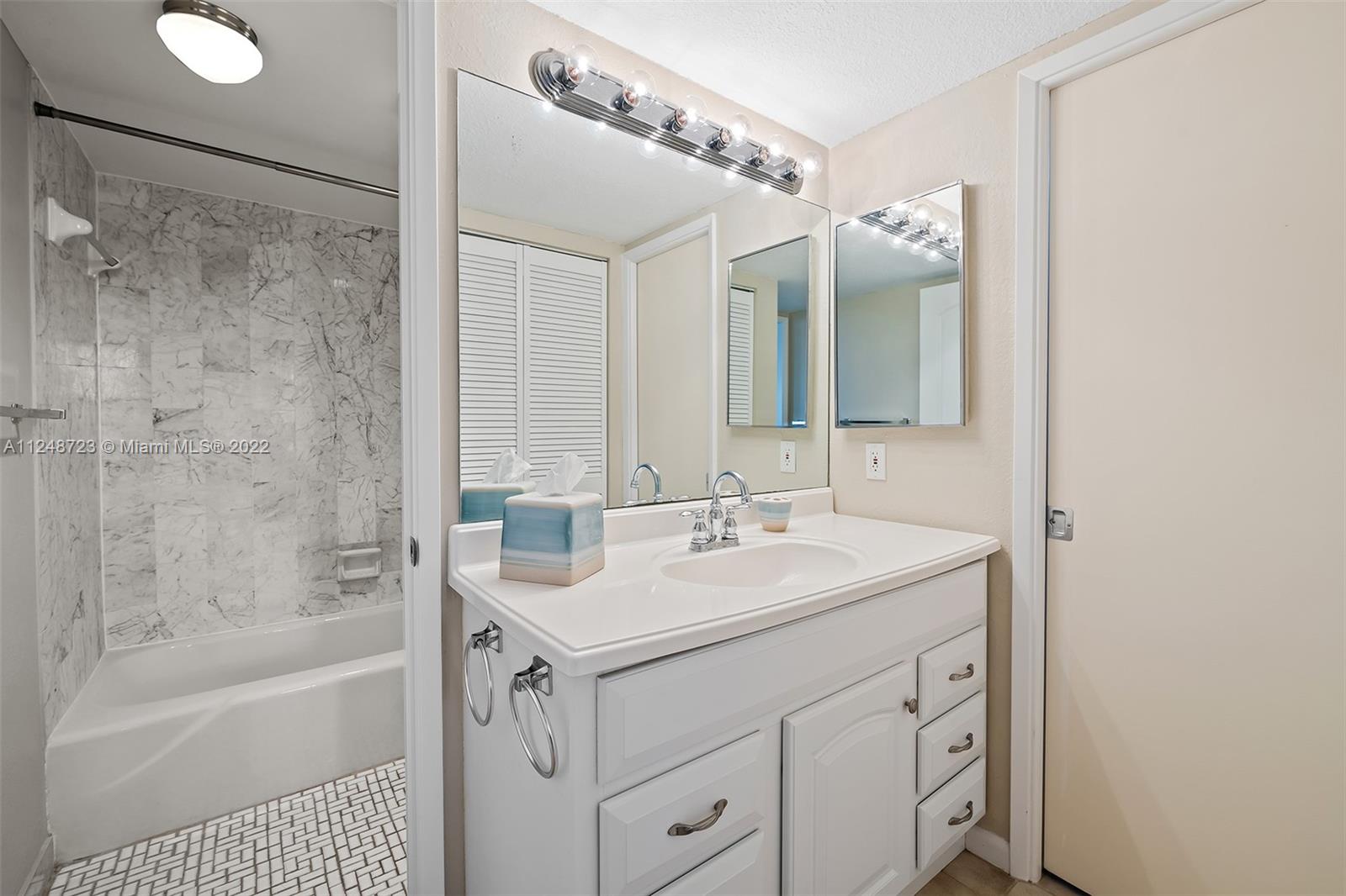 1401 North Riverside Drive, Unit 503 Pompano Beach, FL 33062 - Photo 20 of 30 a bathroom with a sink a toilet a mirror and shower