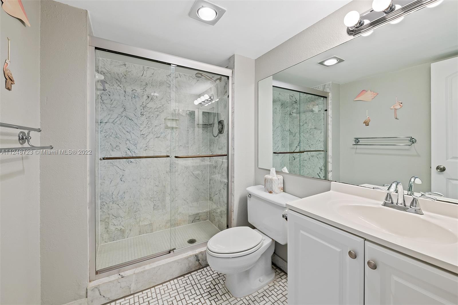 1401 North Riverside Drive, Unit 503 Pompano Beach, FL 33062 - Photo 25 of 30 a bathroom with a sink toilet and shower
