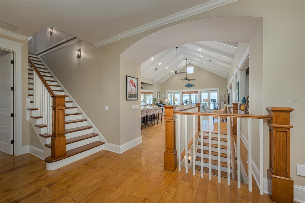 526 56th Street Holmes Beach, FL 34217 - Photo 19 of 99 a view of entryway with stairs and wooden floor
