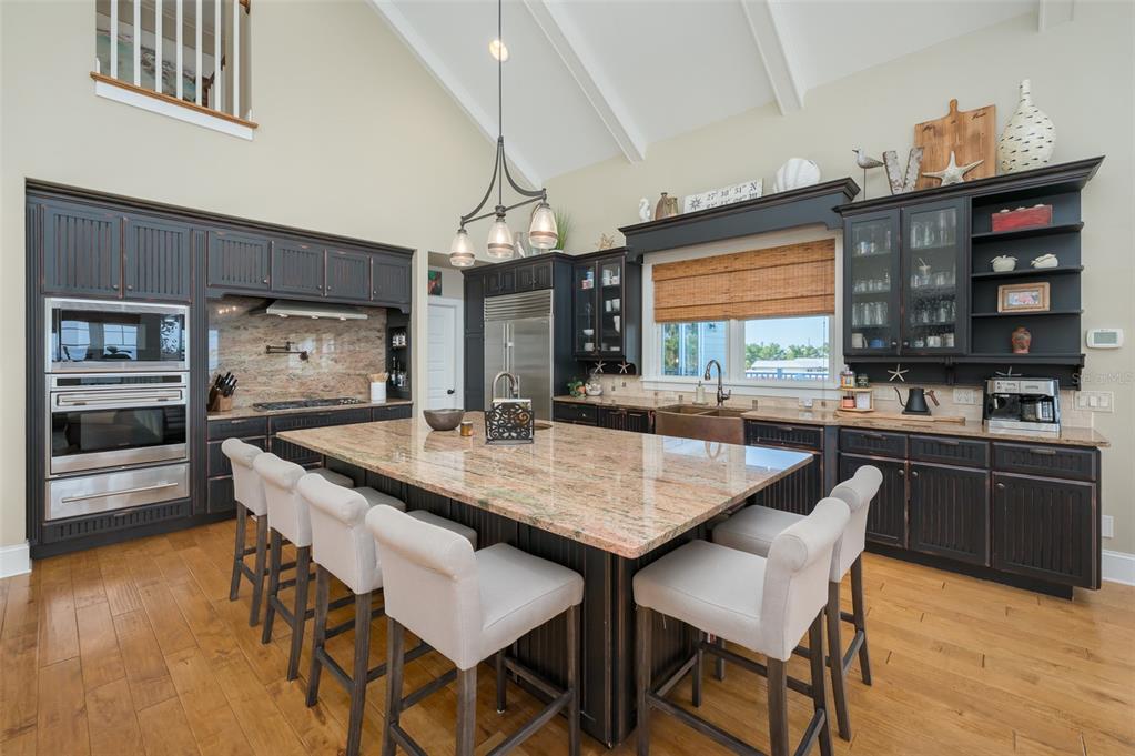 526 56th Street Holmes Beach, FL 34217 - Photo 27 of 99 a kitchen with stainless steel appliances granite countertop a kitchen island a stove and a sink