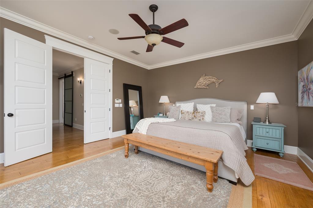 526 56th Street Holmes Beach, FL 34217 - Photo 35 of 99 a bed room with a bed and a ceiling fan