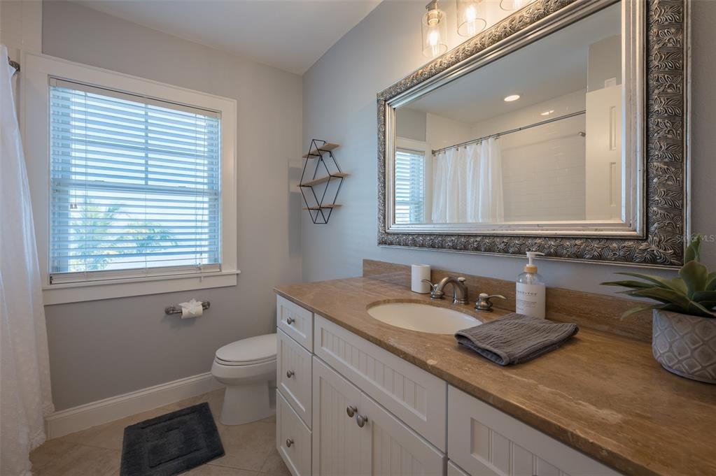 526 56th Street Holmes Beach, FL 34217 - Photo 47 of 99 a bathroom with a granite countertop sink and a mirror