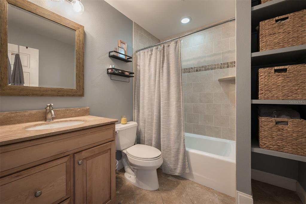 526 56th Street Holmes Beach, FL 34217 - Photo 49 of 99 a bathroom with a granite countertop sink toilet and shower