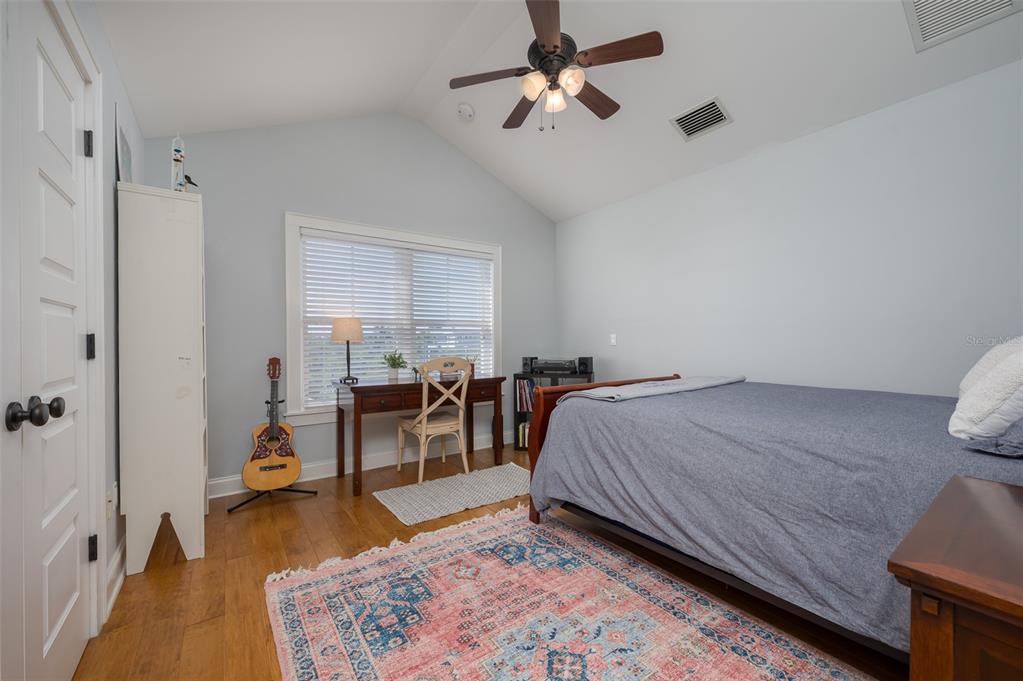 526 56th Street Holmes Beach, FL 34217 - Photo 50 of 99 a bed room with a bed furniture and a wooden floor