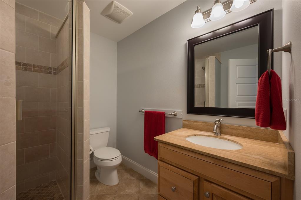 526 56th Street Holmes Beach, FL 34217 - Photo 51 of 99 a bathroom with a granite countertop sink toilet and shower