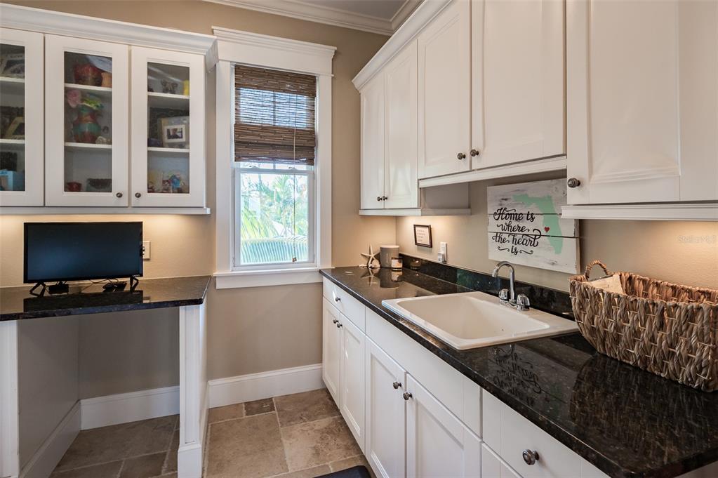 526 56th Street Holmes Beach, FL 34217 - Photo 54 of 99 a kitchen with a sink and cabinets
