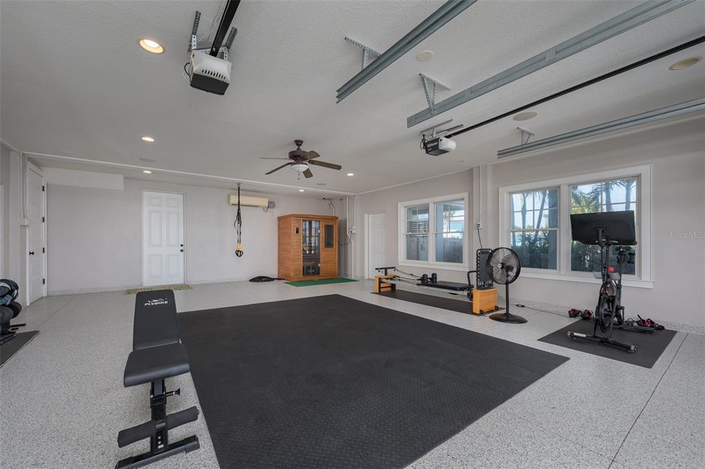 526 56th Street Holmes Beach, FL 34217 - Photo 58 of 99 a living room with lots of furniture and gym equipment