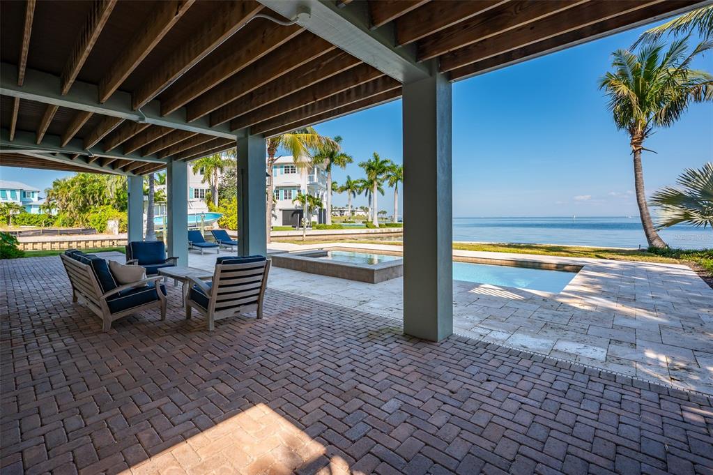 526 56th Street Holmes Beach, FL 34217 - Photo 60 of 99 a view of a swimming pool with a lounge chairs