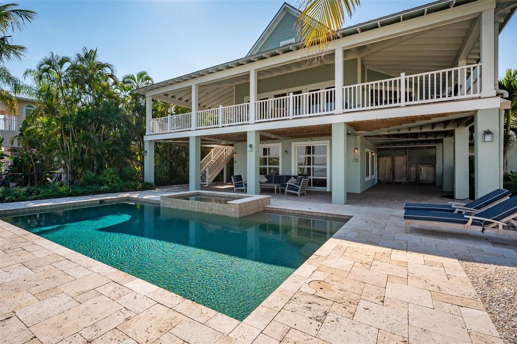 526 56th Street Holmes Beach, FL 34217 - Photo 67 of 99 a view of a house with swimming pool and sitting area