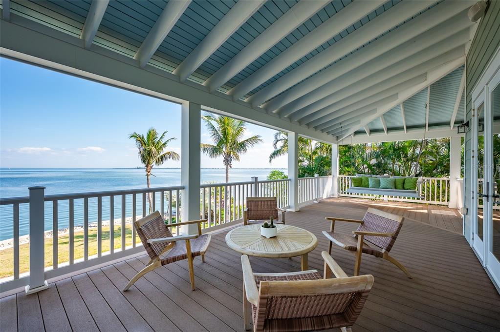 526 56th Street Holmes Beach, FL 34217 - Photo 78 of 99 a view of balcony with furniture and wooden floor