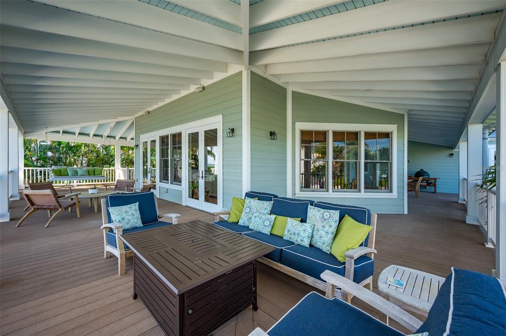 526 56th Street Holmes Beach, FL 34217 - Photo 80 of 99 a outdoor space with patio the couches and a dining table with garden view