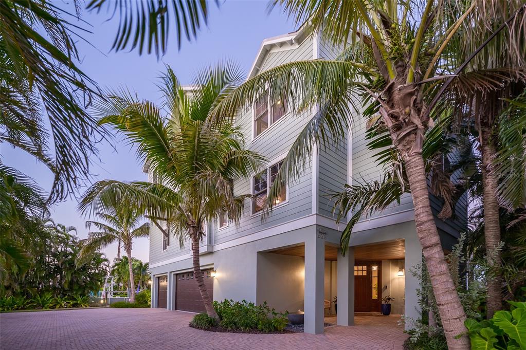 526 56th Street Holmes Beach, FL 34217 - Photo 82 of 99 a view of a palm trees front of house