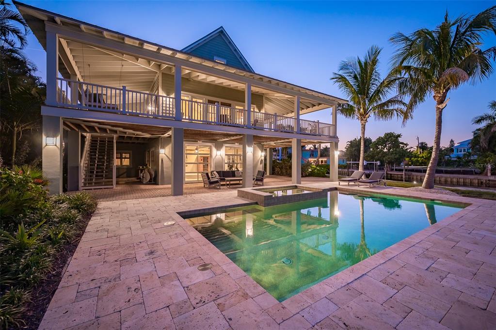 526 56th Street Holmes Beach, FL 34217 - Photo 90 of 99 a view of a house with swimming pool and sitting area