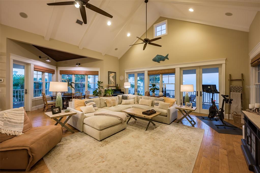 526 56th Street Holmes Beach, FL 34217 - Photo 96 of 99 a living room with furniture ceiling fan and a rug