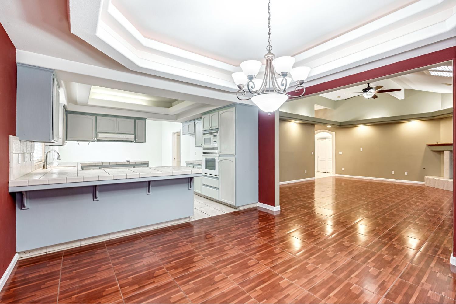 3410 Doubletree Way Madera, CA 93637 - Photo 11 of 34 a view of an empty room and kitchen with wooden floor