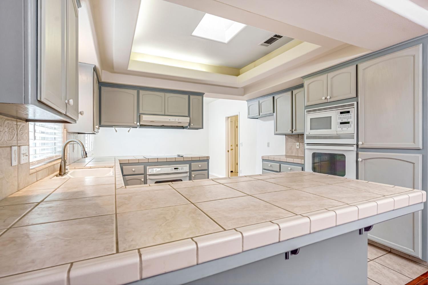 3410 Doubletree Way Madera, CA 93637 - Photo 12 of 34 a bedroom with a bed dresser and a window