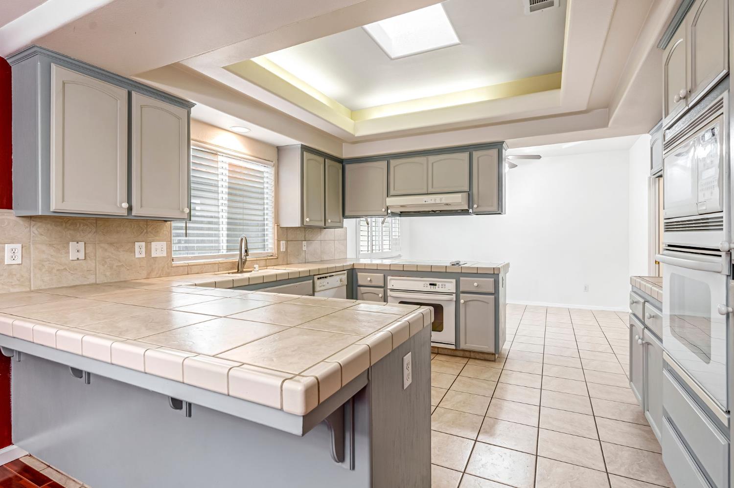 3410 Doubletree Way Madera, CA 93637 - Photo 13 of 34 a kitchen with a stove a sink and a refrigerator