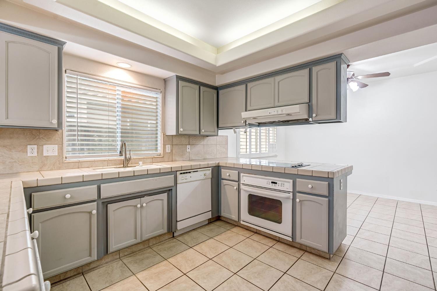 3410 Doubletree Way Madera, CA 93637 - Photo 14 of 34 a kitchen with granite countertop cabinets stainless steel appliances and a sink