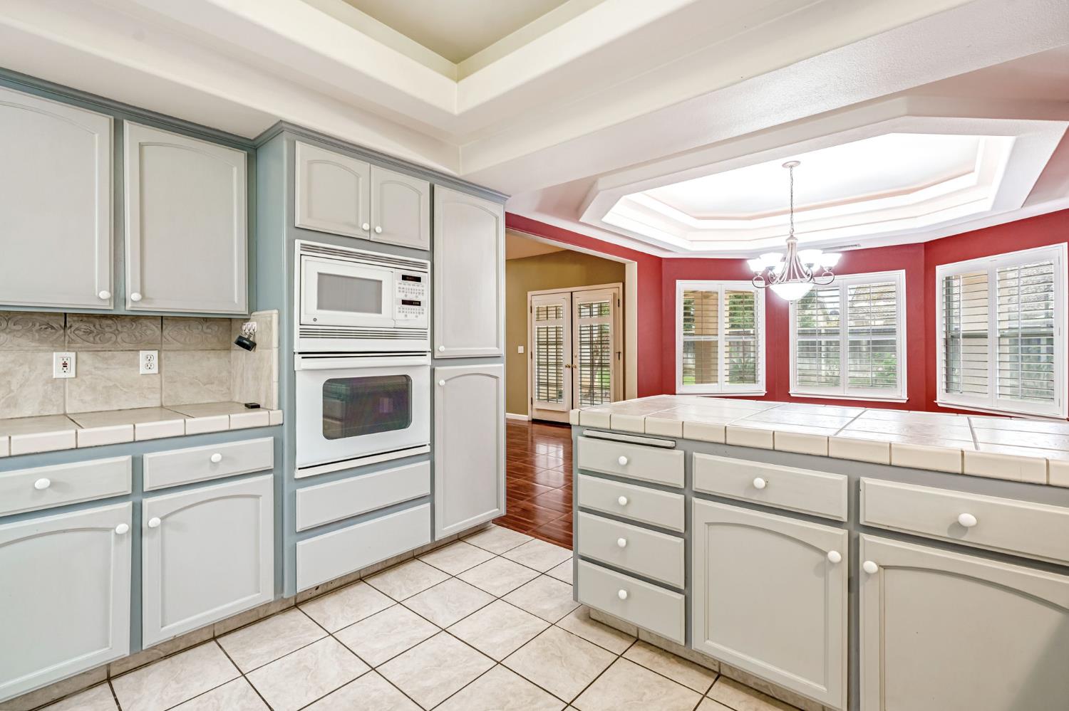 3410 Doubletree Way Madera, CA 93637 - Photo 18 of 34 a kitchen with white cabinets and white appliances