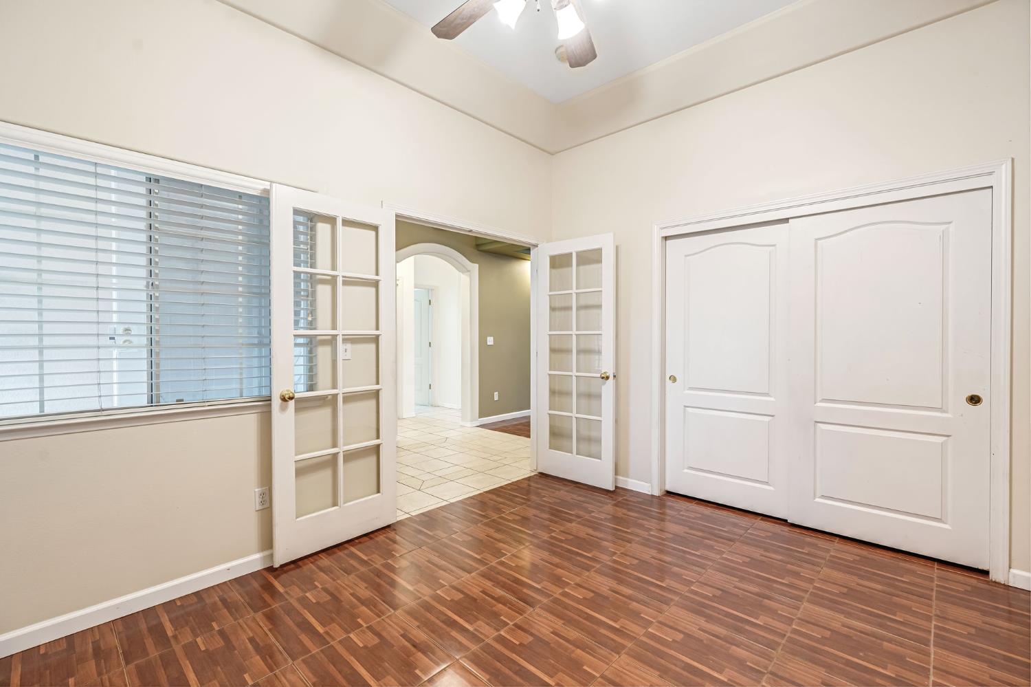 3410 Doubletree Way Madera, CA 93637 - Photo 23 of 34 an empty room with wooden floor cabinet and windows