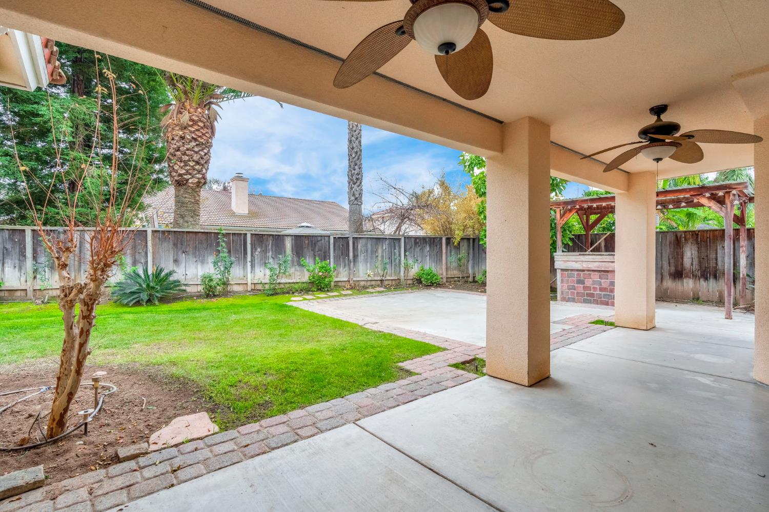 3410 Doubletree Way Madera, CA 93637 - Photo 31 of 34 a front view of a house with a yard and porch